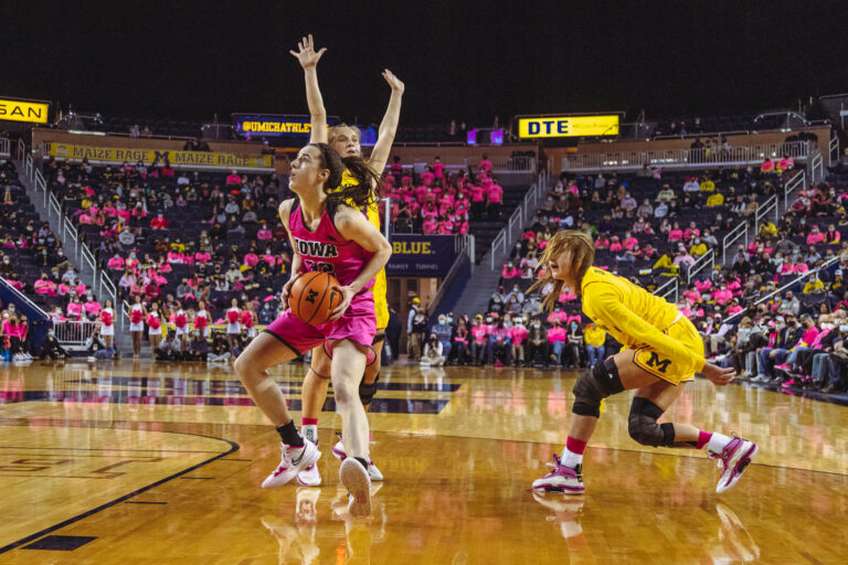 Caitlin Clark playing NCAA basketball for Iowa
